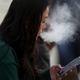 A pedestrian smokes an e-cigarette on November 08, 2019 in San Francisco, California.